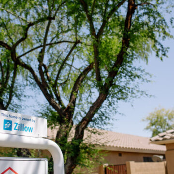 Zillow, facing big losses, quits flipping houses and will lay off a quarter of its staff.